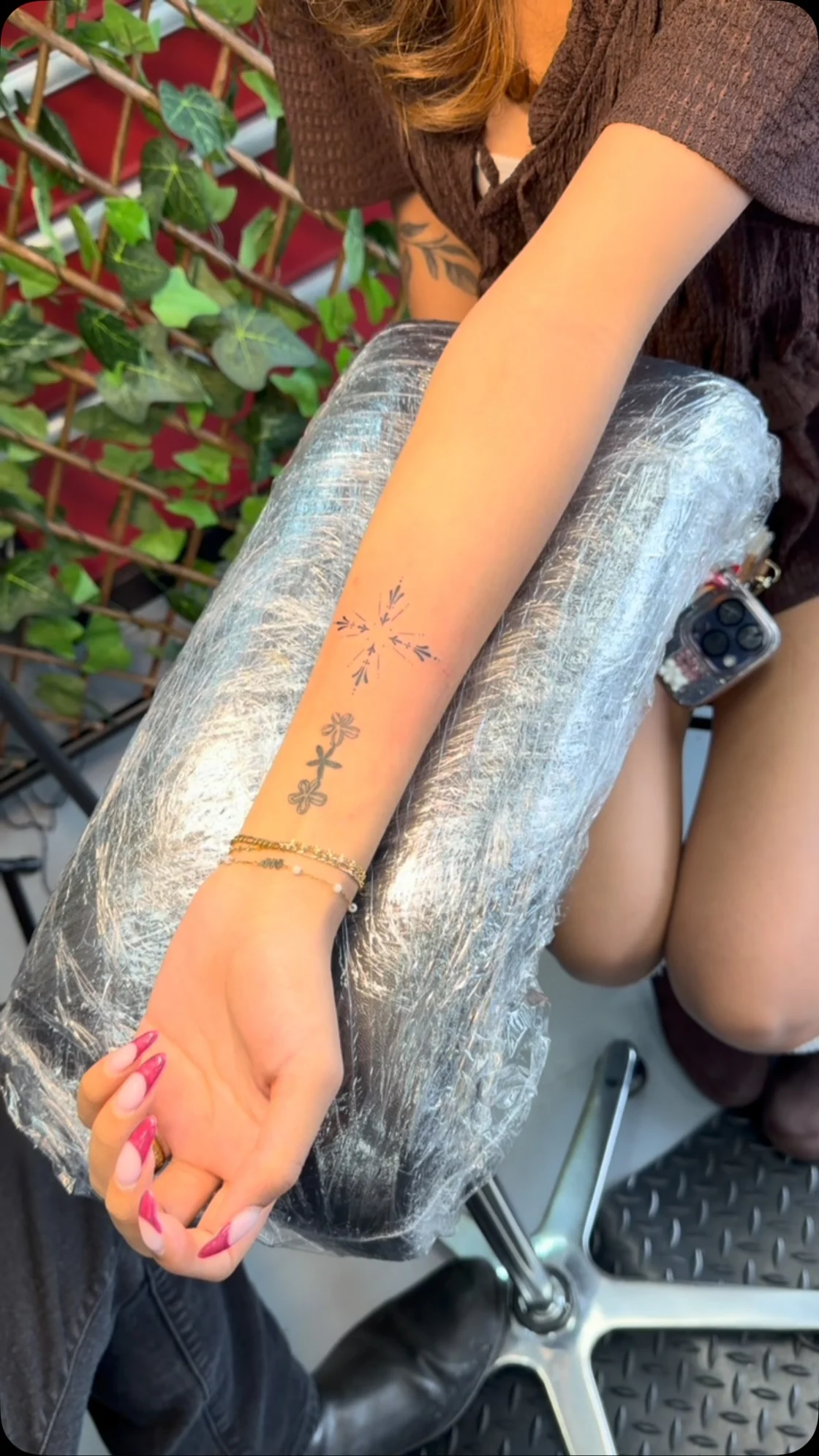 The poster captures small fine line marks and symbols arranged across a forearm during an event tattoo session. Tattoo work by Brian of Vicious Ink.